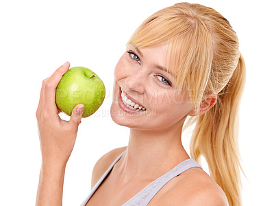 Buy stock photo Studio portrait of an attractive young woman holding an apple isolated on white