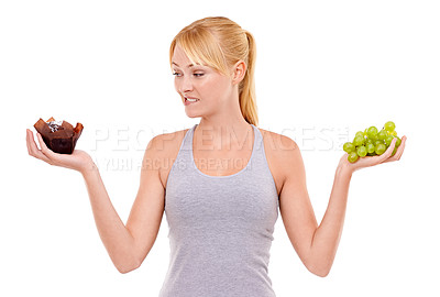 Buy stock photo Portrait, confused and woman with choice of fruit, cake or healthy food to lose weight in studio. Decision, face and girl with grapes vs chocolate dessert for diet, nutrition and white background.