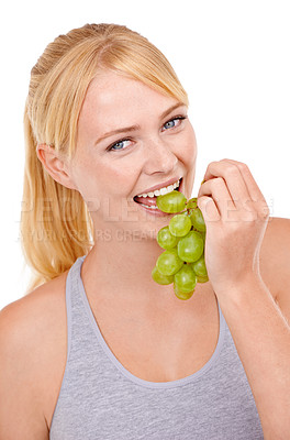 Buy stock photo Studio, woman and portrait with eating grapes for vitamin c, vegan and diet for wellness. Food, face and happy person with fruit for detox, gut health and nutrition benefits on white background
