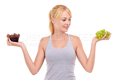 Buy stock photo Woman, thinking and healthy diet or chocolate in studio with white background in backdrop. Girl, choice and decision between dessert or fruit for nutrition in food, grapes and care for wellness