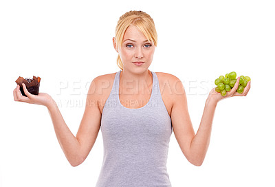 Buy stock photo Woman, confused and dessert or fruit in studio with white background in backdrop. Girl, choice and decision between muffin or grapes for nutrition in food, care and healthy diet for weight loss