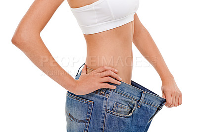 Buy stock photo Diet, health and woman with big pants in studio for weight loss, fitness or exercise results. Wellness, body and closeup of female person with jeans for measuring slim stomach by white background.