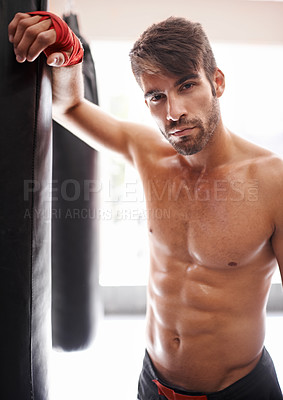 Buy stock photo Man, portrait and ready for boxing in gym, fitness and topless for exercise and workout. Male person, bodybuilder and punching bag for challenge or practice, training and serious face for competition