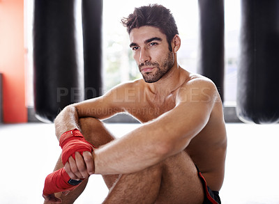 Buy stock photo Man, boxer and workout in gym for combat, training and determination with gloves for match. Male athlete, mma and fighter at fitness studio for practicing for competition, challenge and kickboxing