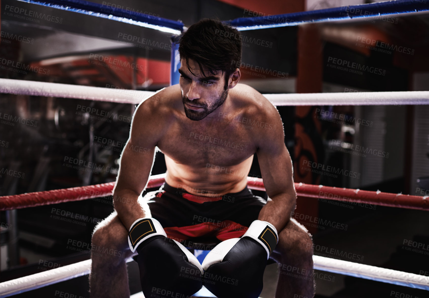 Buy stock photo MMA, boxer and man sitting in ring ready for challenge, competitive and confident from training in gym. Male person, healthy and fitness from practice in exercise studio as athlete  and fighter