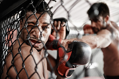 Buy stock photo Face, hit and men in cage for fight, kickboxing competition and challenge in fitness with sports in gym. Boxing match, strong fighter and knockout with exercise, practice and power in battle together