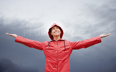 Buy stock photo Cropped shot of an attractive young woman standing in the rain