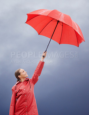 Buy stock photo A beautiful young woman standing outside with her red umbrella