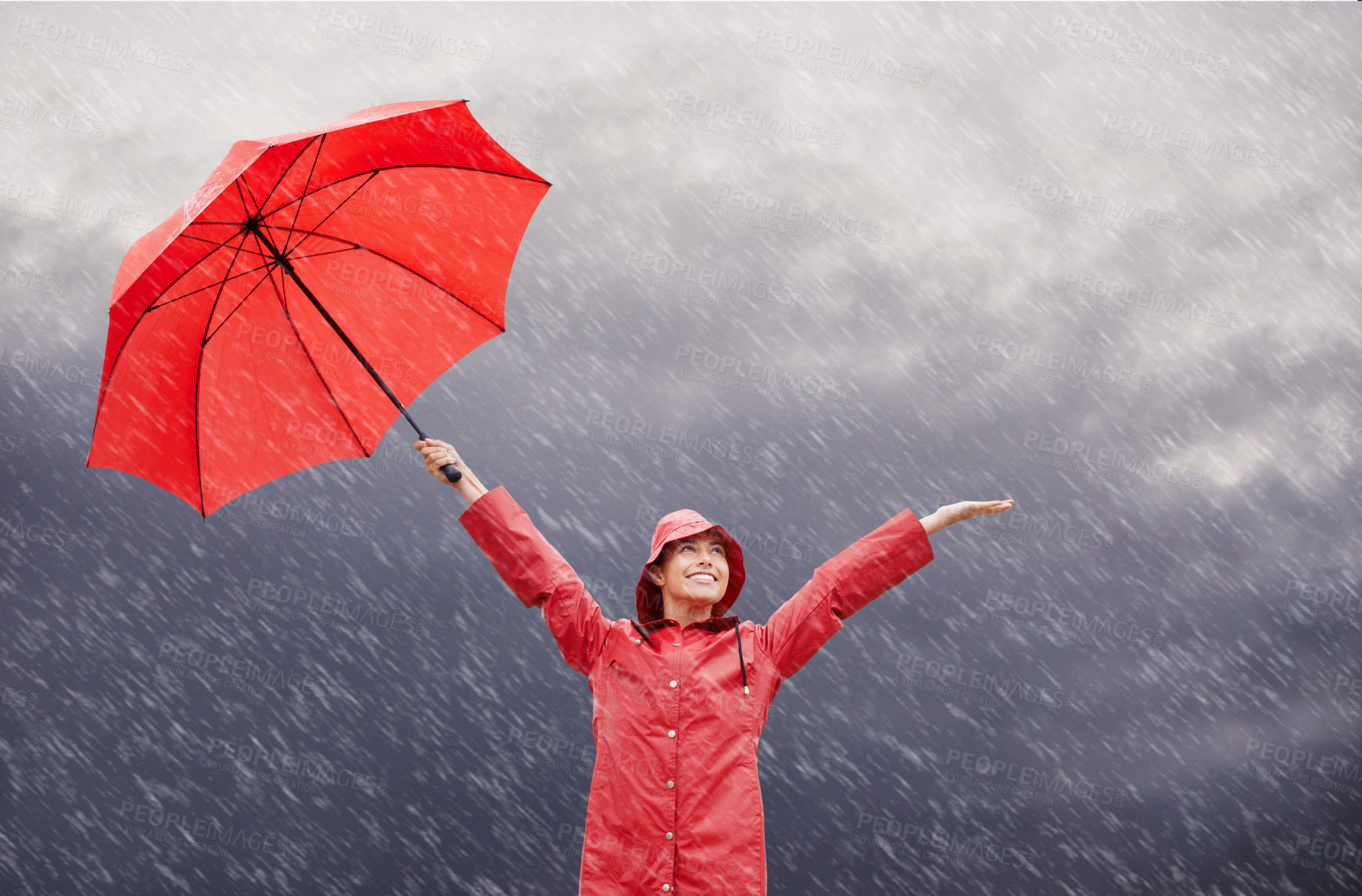Buy stock photo A beautiful young woman standing outside with her red umbrella