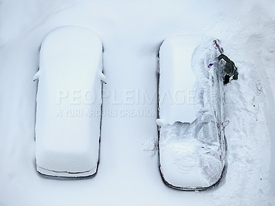 Buy stock photo High angle shot of a two cars covered in snow