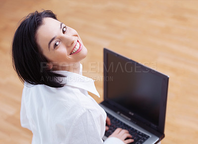Buy stock photo High angle portrait of an attractive young woman using her laptop