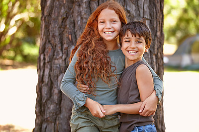 Buy stock photo Happy children, portrait and tree with hug for outdoor holiday, weekend or care together in nature. Little girl, boy and kids with smile for embrace, support or friends enjoying summer day at forest