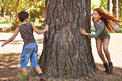 Buy stock photo Children, forest or playing tag for fun with brother and sister sibling outdoor in nature together. Kids, girl and boy running around tree in woods to catch for summer game of leisure or recreation
