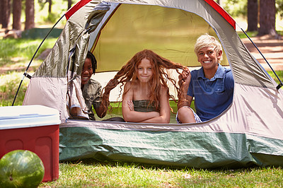 Buy stock photo Portrait, funny and children in tent for camp on vacation, adventure or holiday with fun. Smile, travel and young boy kids pull hair of girl for joke in outdoor field, forest or woods on weekend trip