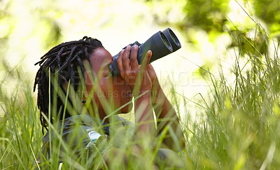 Buy stock photo Nature, binoculars and kid in grass for exploring in park on vacation, adventure or holiday. Travel, forest and young boy child with equipment in lawn in outdoor field or woods on weekend trip.