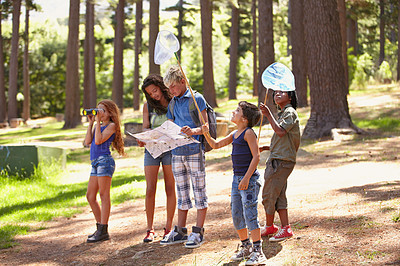 Buy stock photo Nature, adventure and group of children in forest playing with fishing net and map for exploring. Bonding, field and young kids walking, discovery and hobby in outdoor woods together in summer.