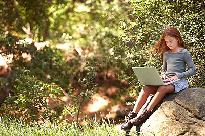 Buy stock photo Distance learning, laptop or girl child in nature for research, development or online assignment in a forest. Remote, pc or kid in park for elearning, reading or web communication with school friends