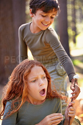 Buy stock photo Shock, children and surprise with food outdoor, boy stealing snack and girl frustrated with friends. Camping, adventure and naughty kids fight with marshmallow on stick or boy on holiday or vacation