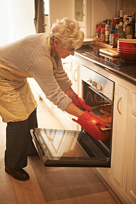 Buy stock photo Senior woman, oven and cooking pie at home in kitchen for food, nutrition and dessert. Female person, elderly lady or retired baking pastry dish on tray, pan or stove for eating, dining and enjoyment