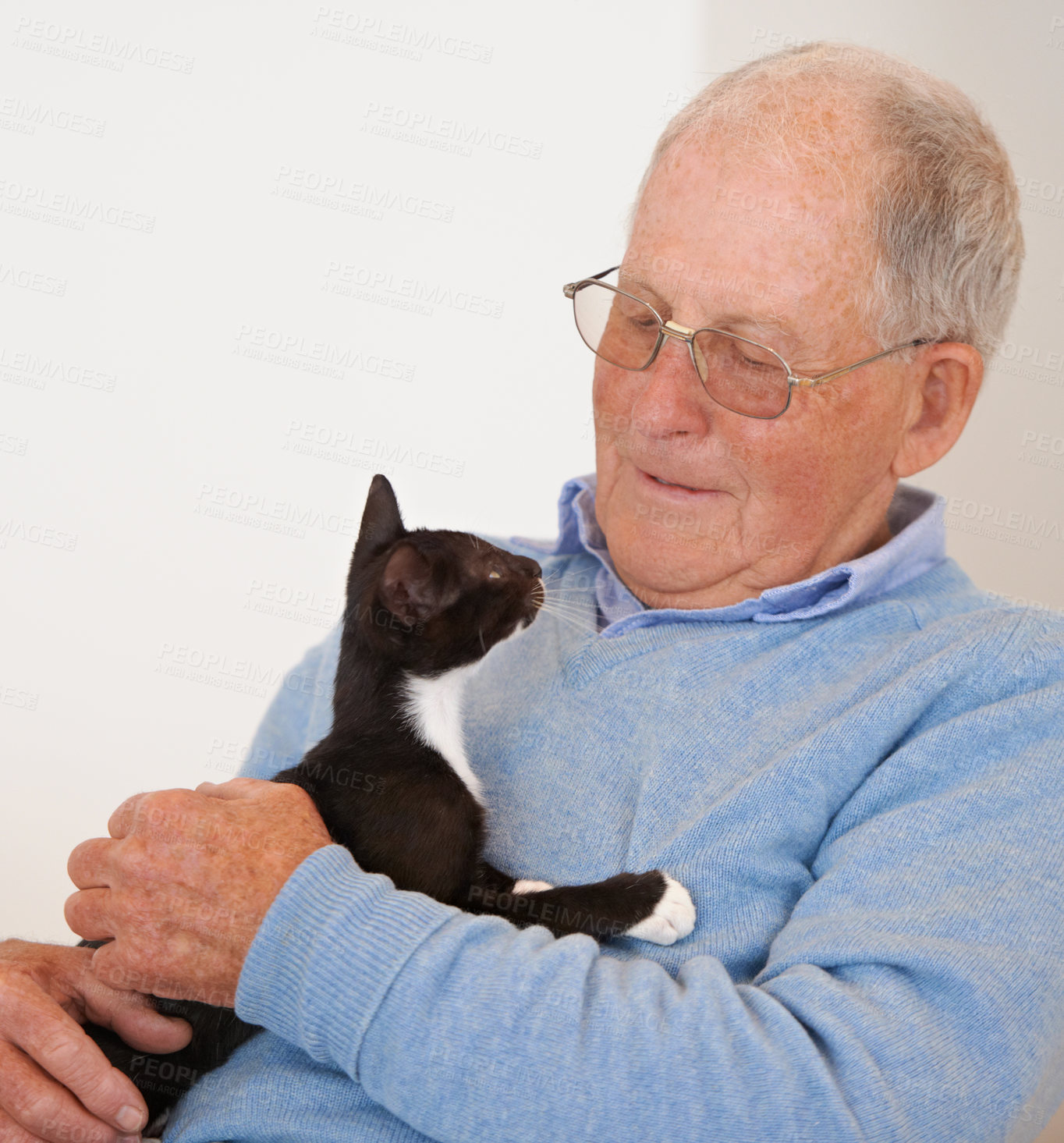 Buy stock photo Happy, home and old man with a cat, bonding and love with joy and caring with support and smile. Pensioner, apartment and elderly guy with animal and playing with a pet and relaxing in a living room