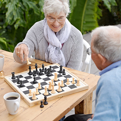 Buy stock photo An elderly couple playing chess together outdoors