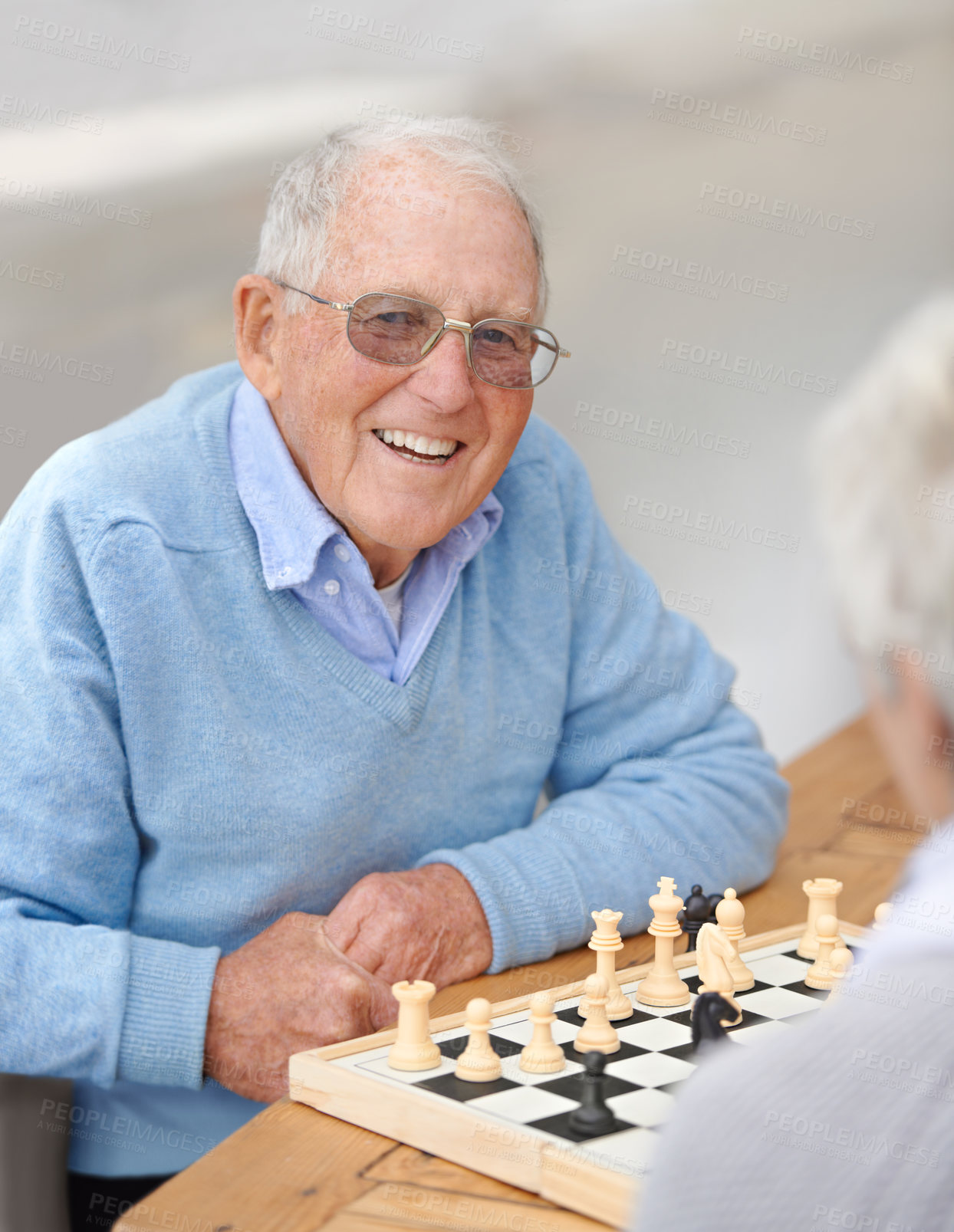 Buy stock photo An elderly couple playing chess together