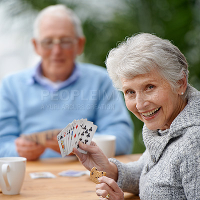 Buy stock photo Two seniors playing cards together
