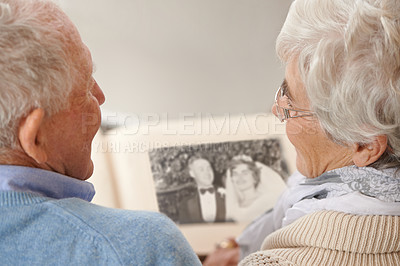Buy stock photo Old couple, photo album and memory nostalgia to remember wedding in retirement for connection, bonding or together. Elderly man, woman and photography book for union commitment, rear view or past