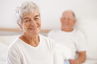 Buy stock photo Shot of a senior couple in their bedroom early in the morning