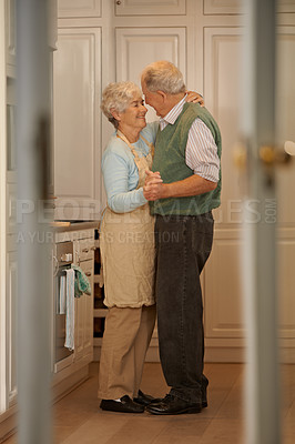 Buy stock photo Elderly, couple and happy with dancing in kitchen for bonding, support and holding hands with romance. Senior, man and woman with hug, embrace and smile for relationship, dancer and love in home 