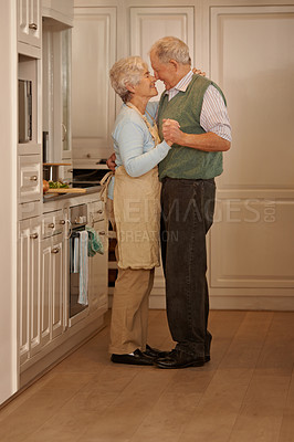 Buy stock photo Senior, couple and love with dancing in kitchen for bonding, support and holding hands while cooking. Elderly, man and woman with hug, embrace and smile for relationship, dancer or happiness in home 