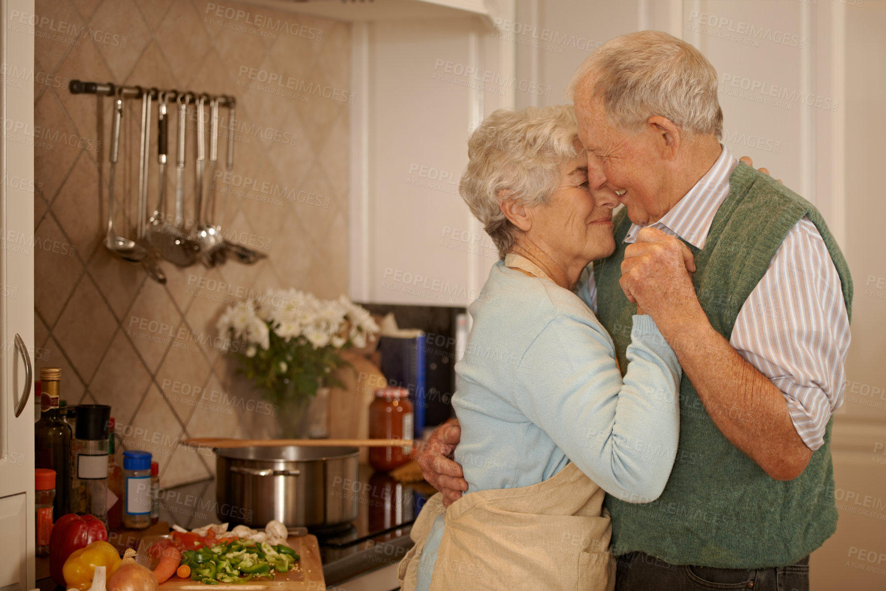 Buy stock photo Cropped shot of an elderly couple standing together in the kitchen