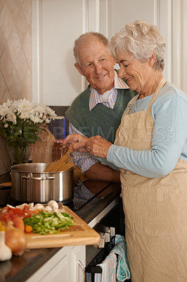 Buy stock photo Senior couple, cooking and stove top in kitchen, food preparation and love at home. Elderly people, healthy meal and organic ingredients for nutrition, vegetables and diet for detox in retirement