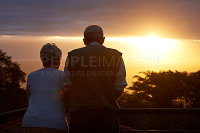 Buy stock photo Senior couple, sunset and view on balcony in outdoors, bonding and love on vacation or holiday. Back, elderly people and dusk on terrace and together in nature, security and travel for marriage