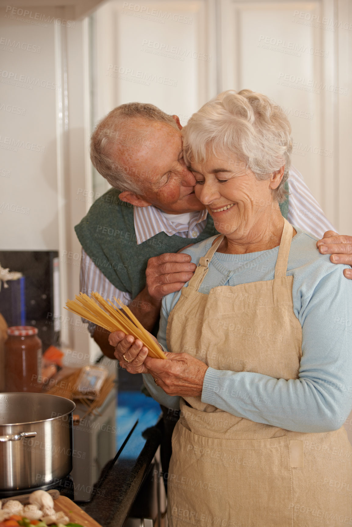 Buy stock photo Cropped shot of an elderly couple standing together in the kitchen