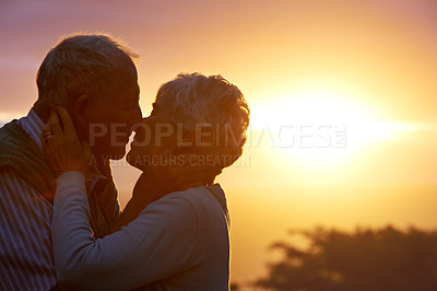 Buy stock photo Sunset, elderly couple or kiss outdoor, care or bonding together for connection in marriage. Man, woman or nose touch for love, romance or embrace for commitment to relationship in retirement on date