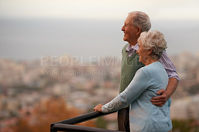 Buy stock photo An elderly couple standing and looking at the view together