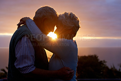 Buy stock photo Sunset, senior couple and embrace outdoor, care and bonding for connection together in nature. Man, woman and touch forehead for love, romance and hug for commitment to relationship in retirement