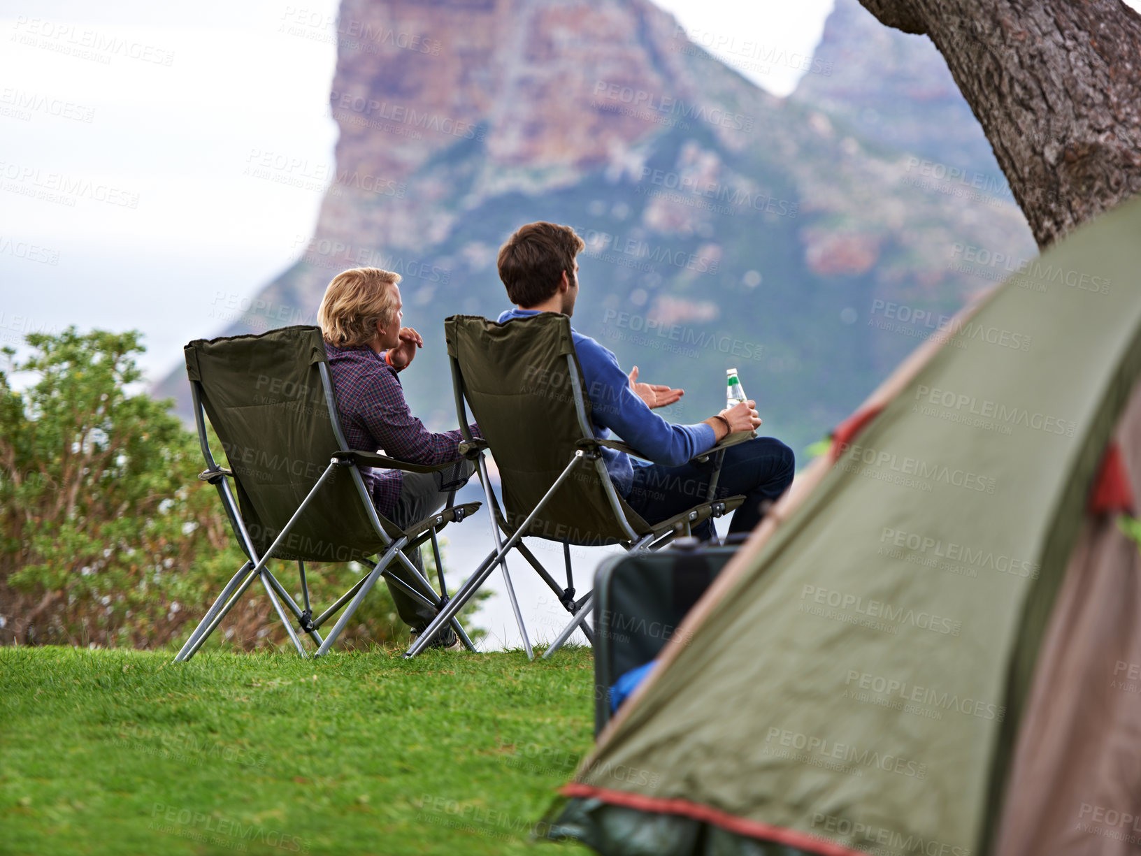 Buy stock photo Two men relaxing at their campsite