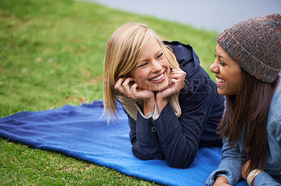 Buy stock photo Happy, friends and relax on blanket for picnic outdoor in summer on holiday or vacation together. Women, smile and laugh in conversation in park, woods or lying on grass in backyard or garden