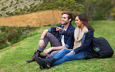 Buy stock photo Shot of a good-looking young couple enjoying an affectionate moment outdoors
