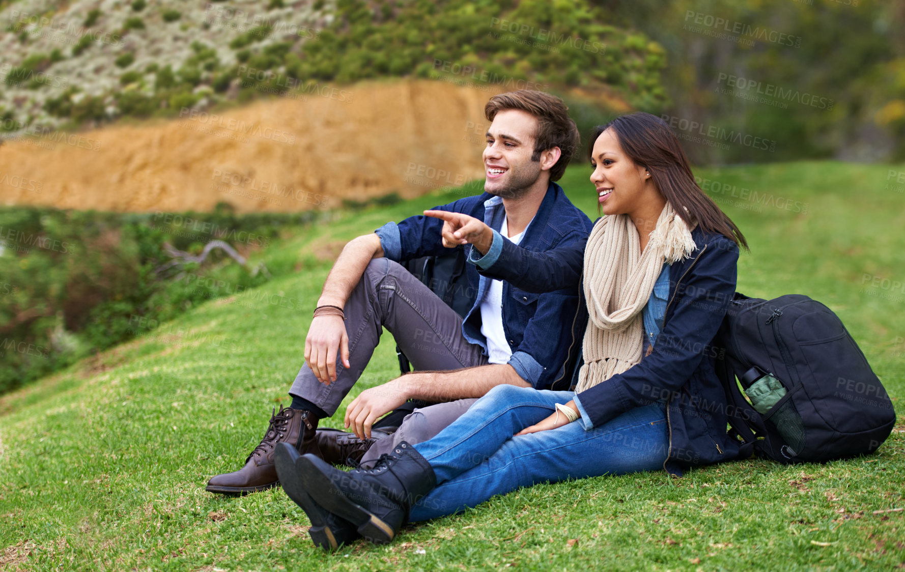 Buy stock photo Shot of a good-looking young couple enjoying an affectionate moment outdoors