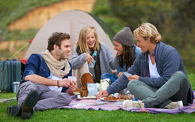 Buy stock photo Nature, camping and people on picnic with food laughing, talking and bonding on vacation. Happy, travel and group of friends eating lunch in outdoor field, park or forest on holiday or weekend trip.