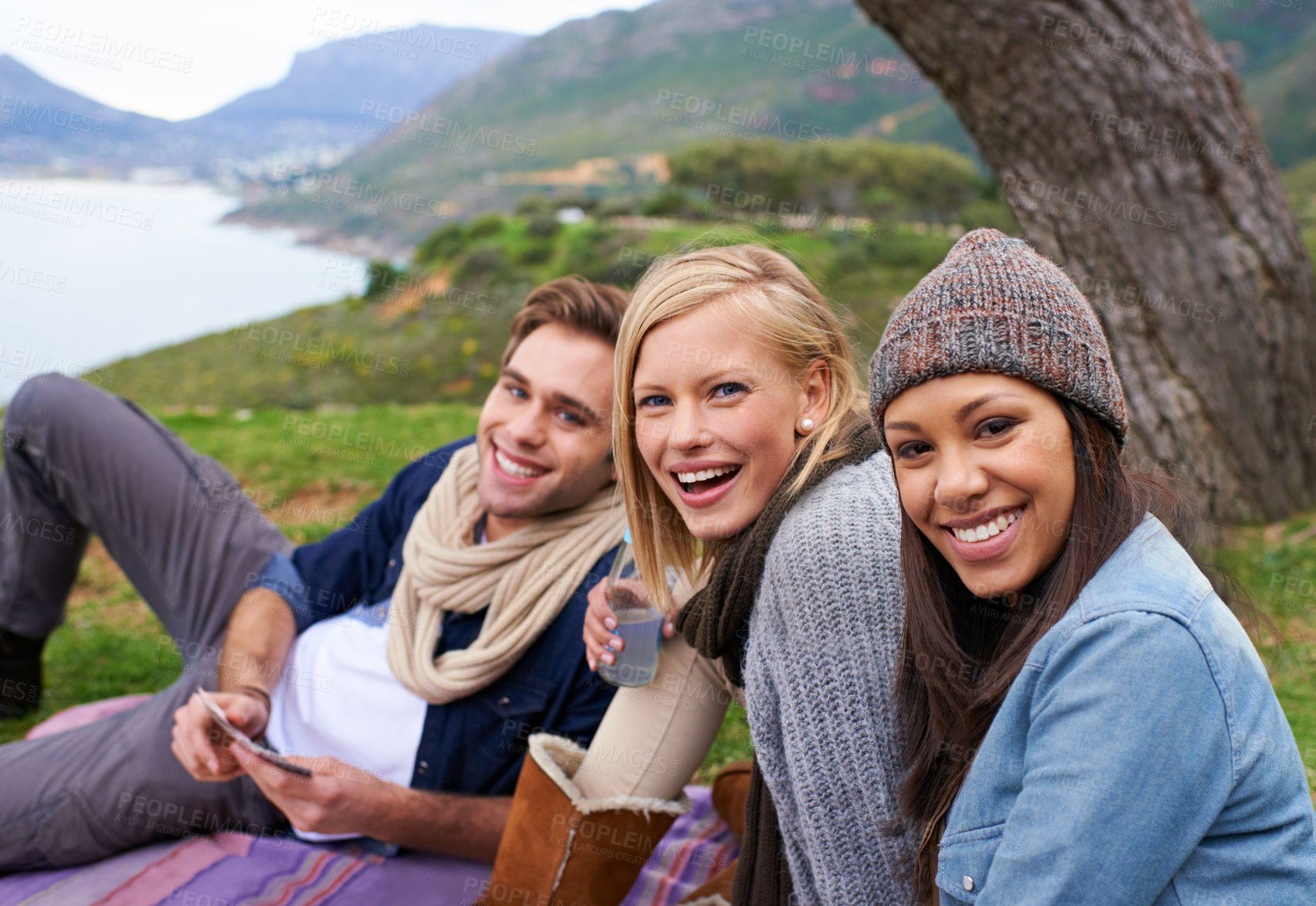 Buy stock photo Nature, smile and portrait of friends on picnic laughing and bonding on vacation or adventure. Happy, travel and group of people relaxing in outdoor field, park or forest on holiday or weekend trip.