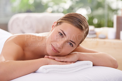 Buy stock photo Woman, spa and massage table for wellness, health and self care for relaxation and portrait and therapy. Female person, luxury resort and body treatment for serenity skincare and detox to destress 