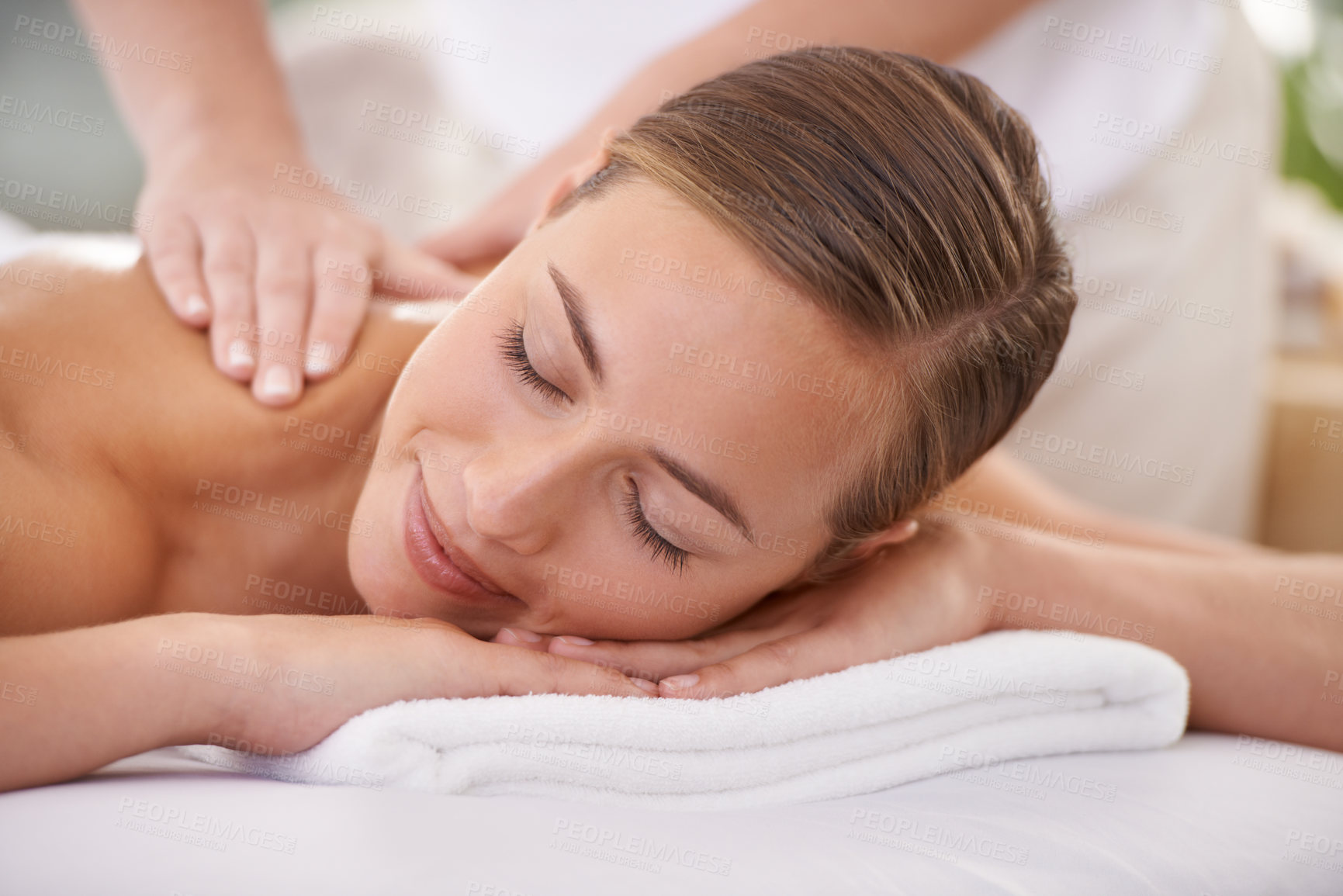 Buy stock photo Spa, face and woman or hands with massage for relax, luxury treatment and happiness with towel. Person, calm and masseuse for body care, pain relief and comfort with smile, wellness and skincare