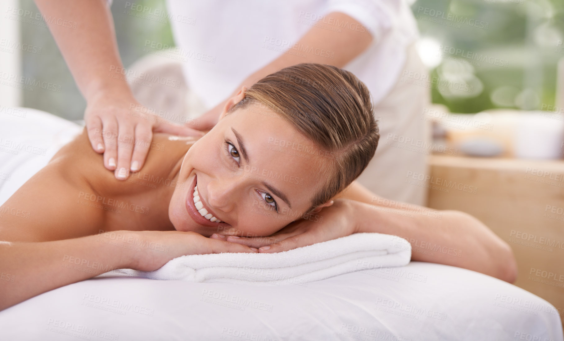Buy stock photo Smile, portrait and woman or hands with massage for relax, luxury treatment and happiness with towel. Person, face and masseuse for body care, pain relief and comfort with spa, wellness and skincare