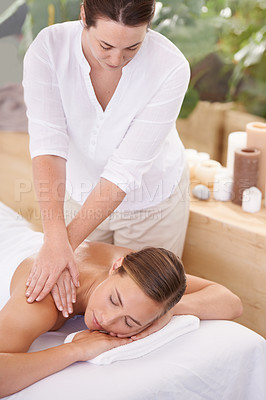 Buy stock photo An attractive young woman having a massage at the spa