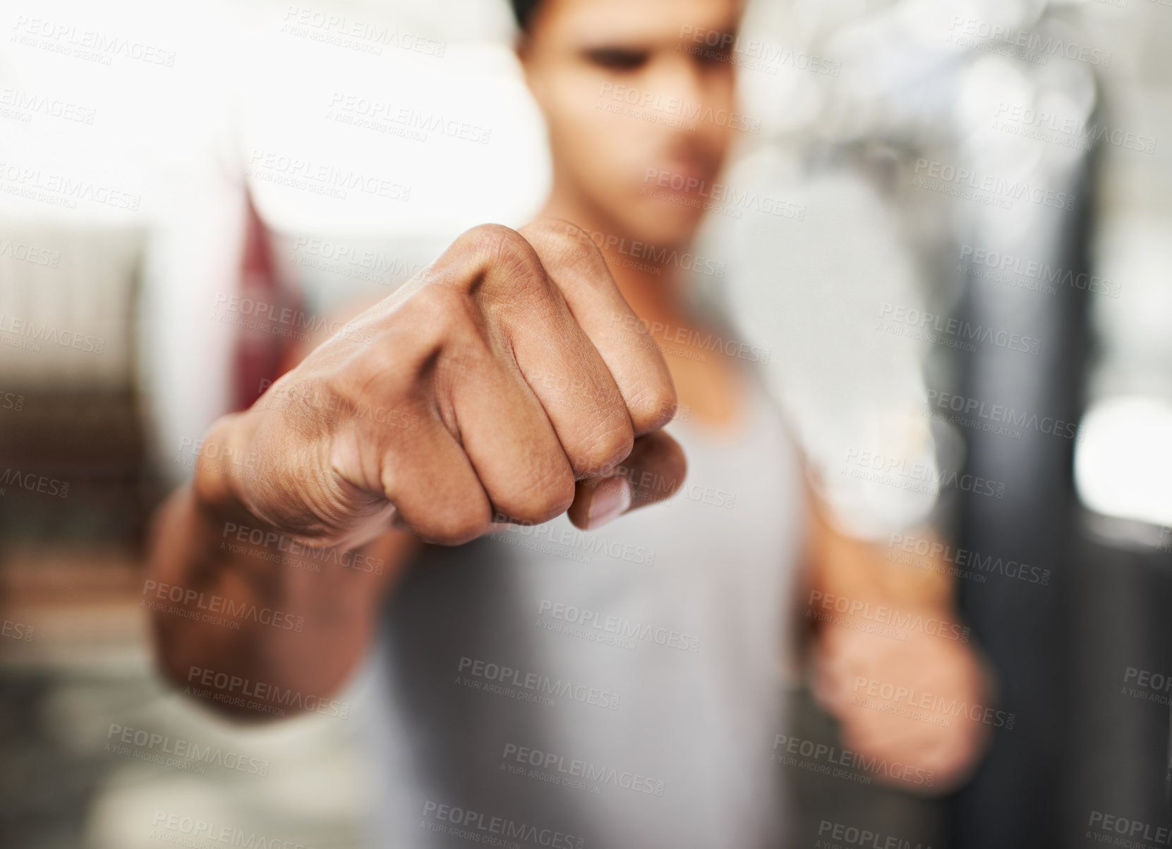 Buy stock photo Shot of a young boxer throwing a punch