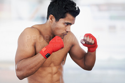 Buy stock photo Shot of a young male boxer training